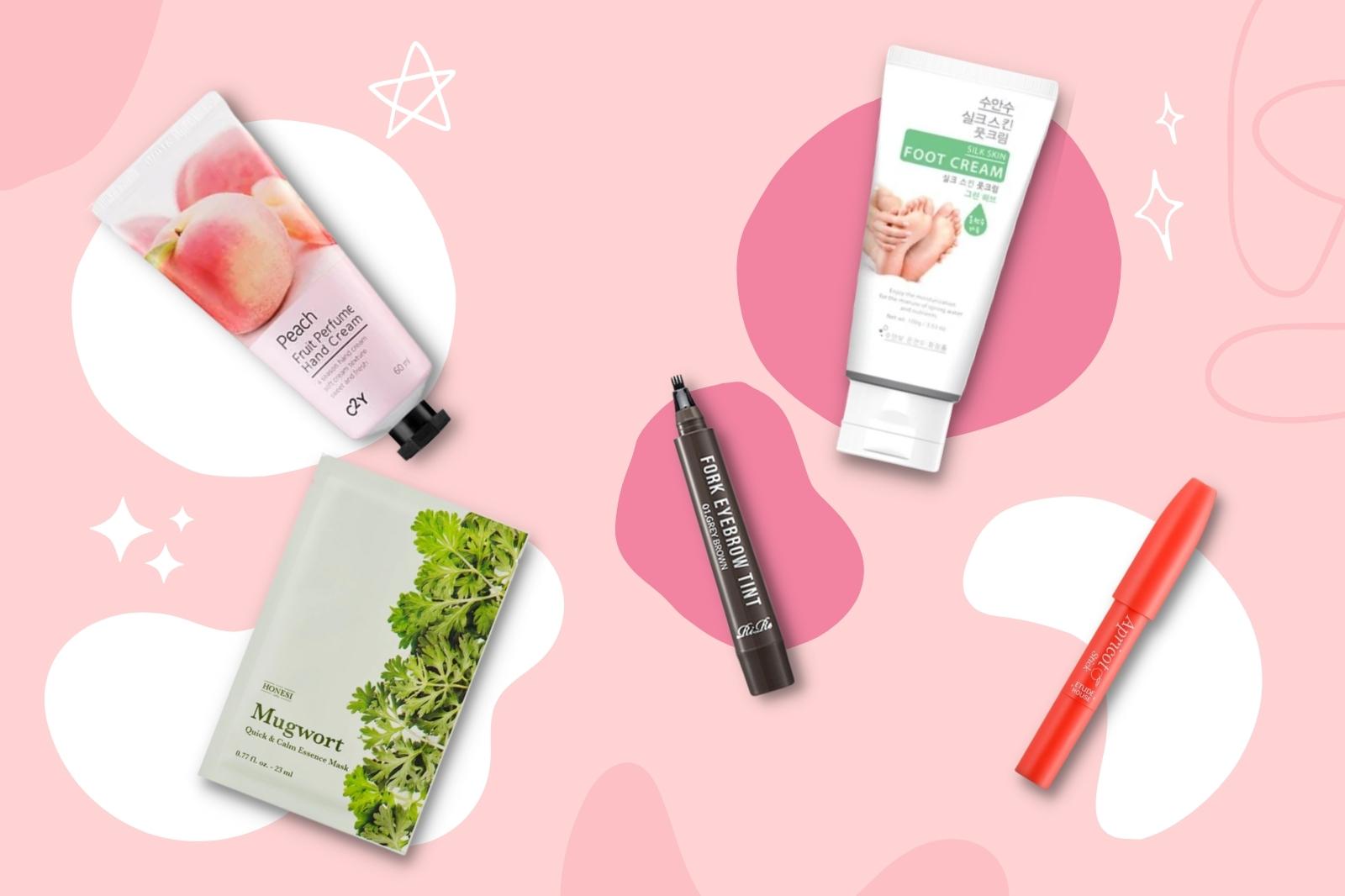 Produits de la KBeauty Box de Mars 2022 avec crème pour les pieds, main, et maquillage sur fond rose.