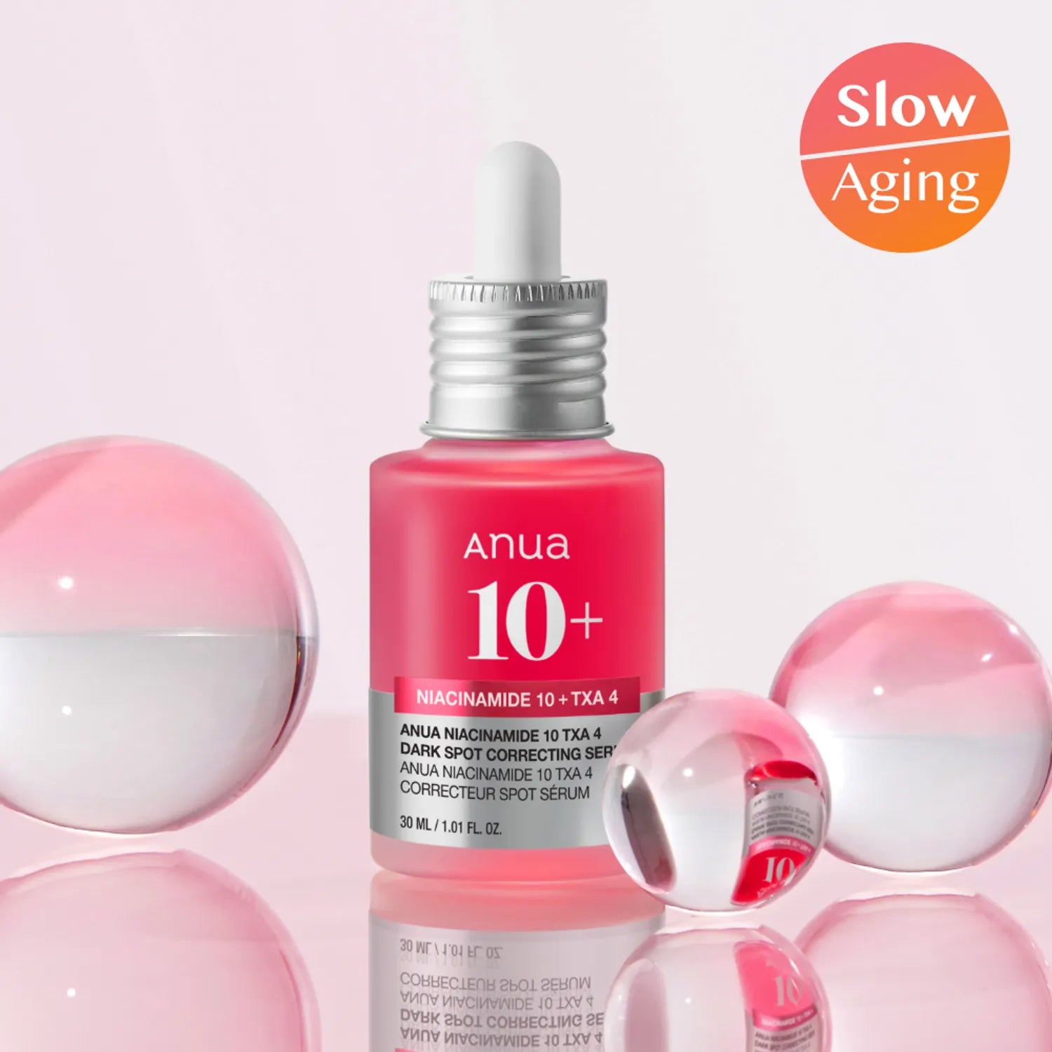 ANUA Niacinamide 10% +TXA 4% Dark Spot Correcting Serum 30ml, flacon rouge ANUA sur fond rose, gouttes et sphères