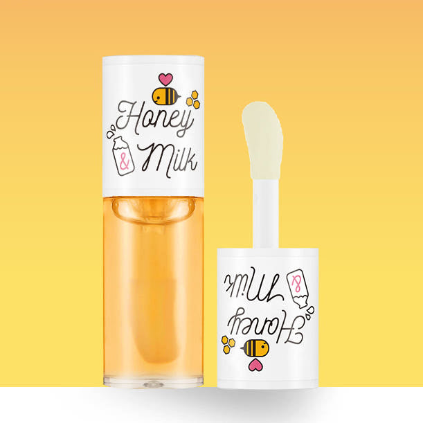 A'PIEU Honey&Milk Lip Oil de la marque A'PIEU : lip oil miel et lait sur fond jaune, packaging et tube visibles.