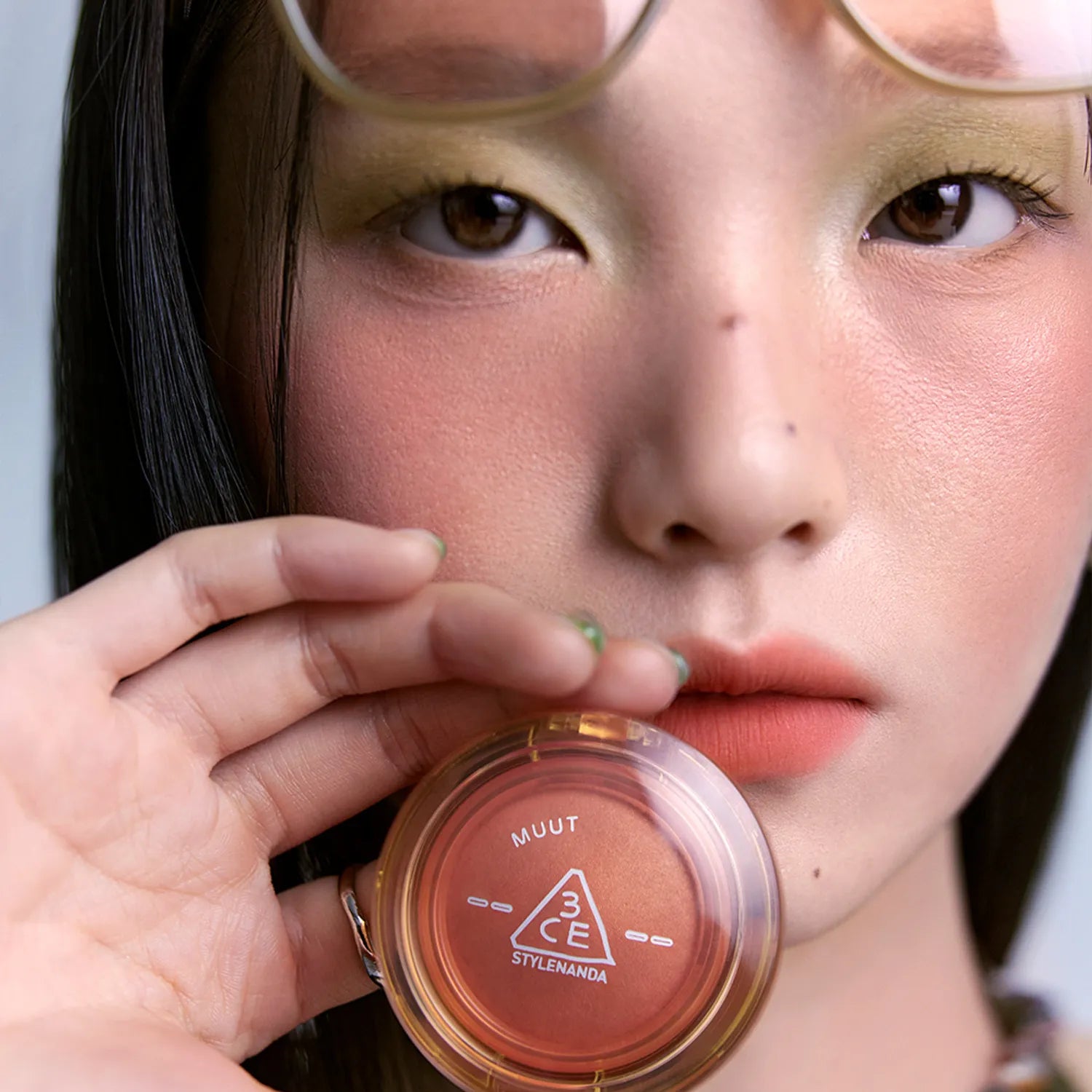 3CE Bouncy Blur Balm de 3CE, baume appliqué sur le visage d’une femme, gros plan beauté maquillage