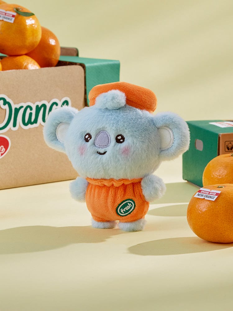 BT21 KOYA BABY PLUSH ORANGE PARTY : peluche KOYA koala orange, officielle LINE, en studio photo sur table