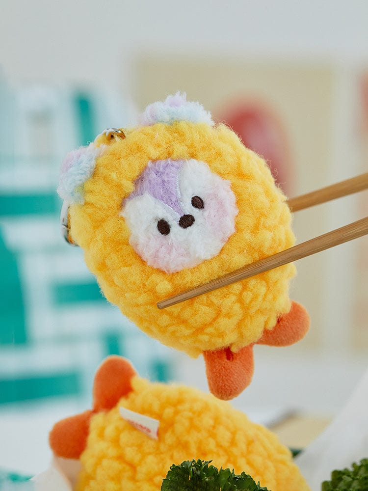 BT21 MANG minini PLUSH KEYRING BUNSIK, porte-clés peluche jaune à lunettes, style K-pop BTS, sur fond flou.