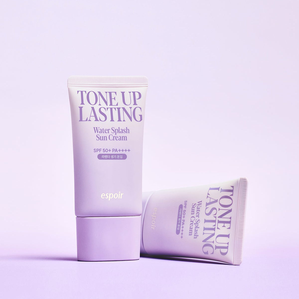 ESPOIR Water Splash Sun Cream Tone Up Lasting SPF 50+ PA++++, tubes crème solaire sur fond rose pastel