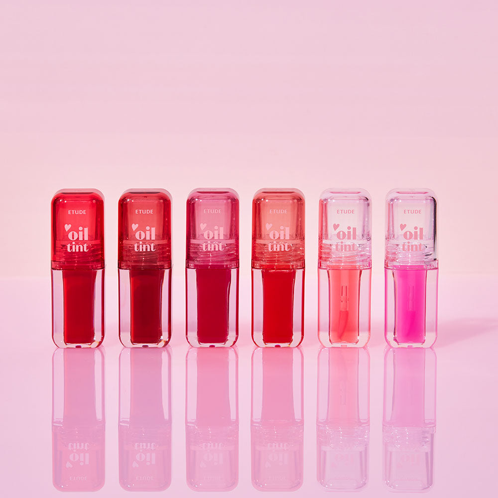 ETUDE Dear Darling Oil Tint : tubes de maquillage roses sur fond rose, présentation produit de la marque ETUDE.