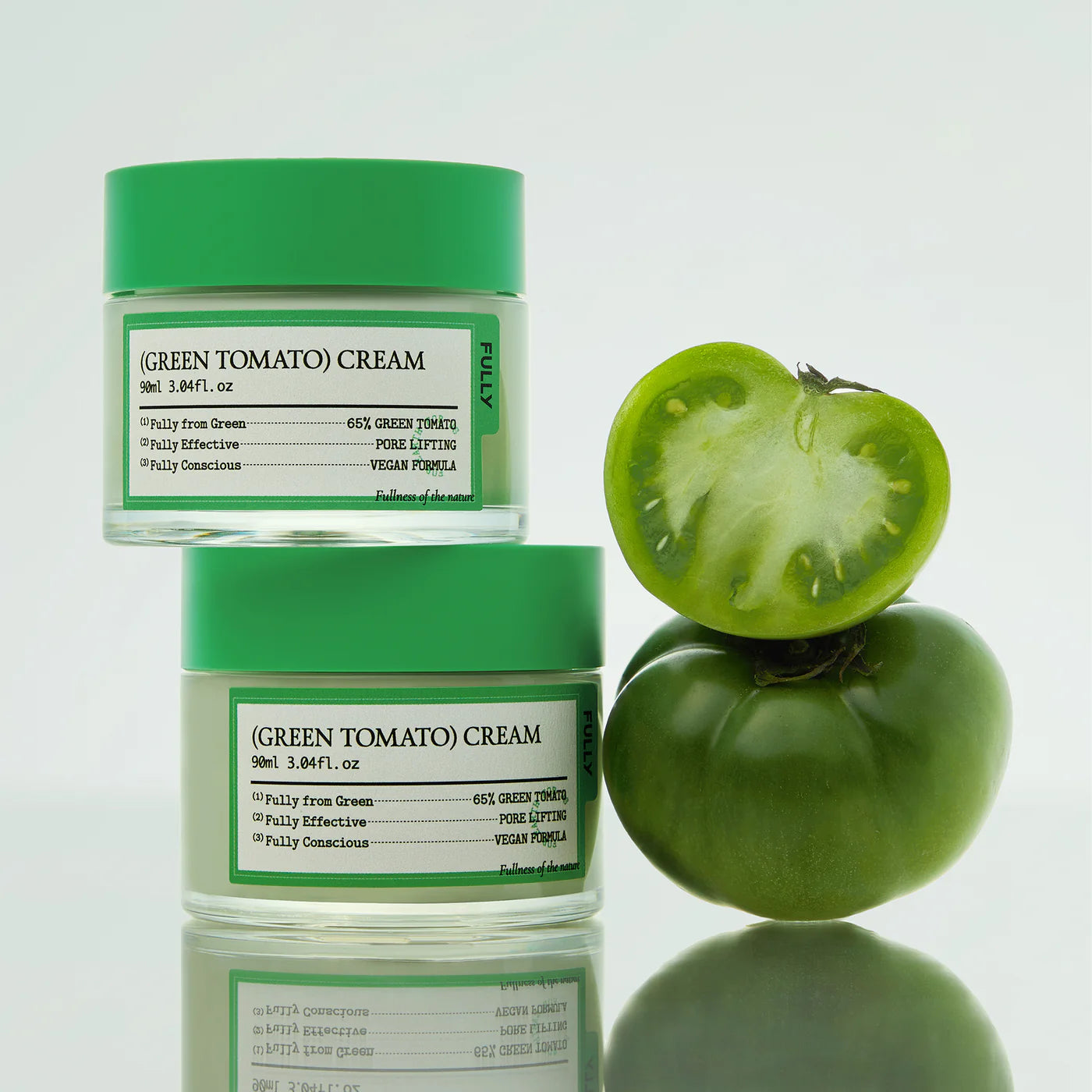 FULLY Green Tomato Cream 90ml : pot de crème verte FULLY et tranches de tomate sur fond blanc.
