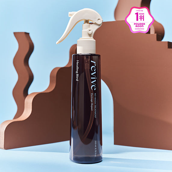 HEALING BIRD Revive No-Wash Treatment Damage Repair 200ml, flacon spray sur fond bleu, marque Healing Bird, cheveux.