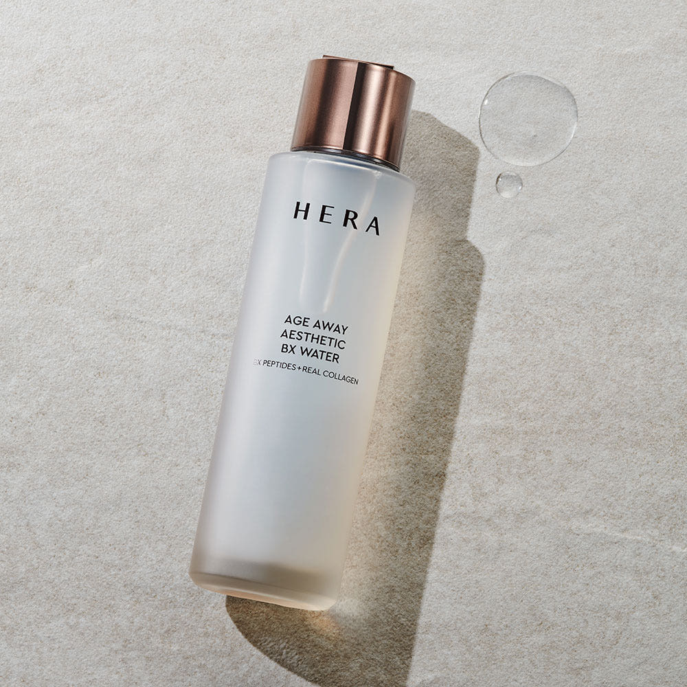 HERA Age Away Aesthetic BX Water 150ml, bouteille HERA sur fond clair; contexte cosmétique et produit de soin, bulle visuelle.