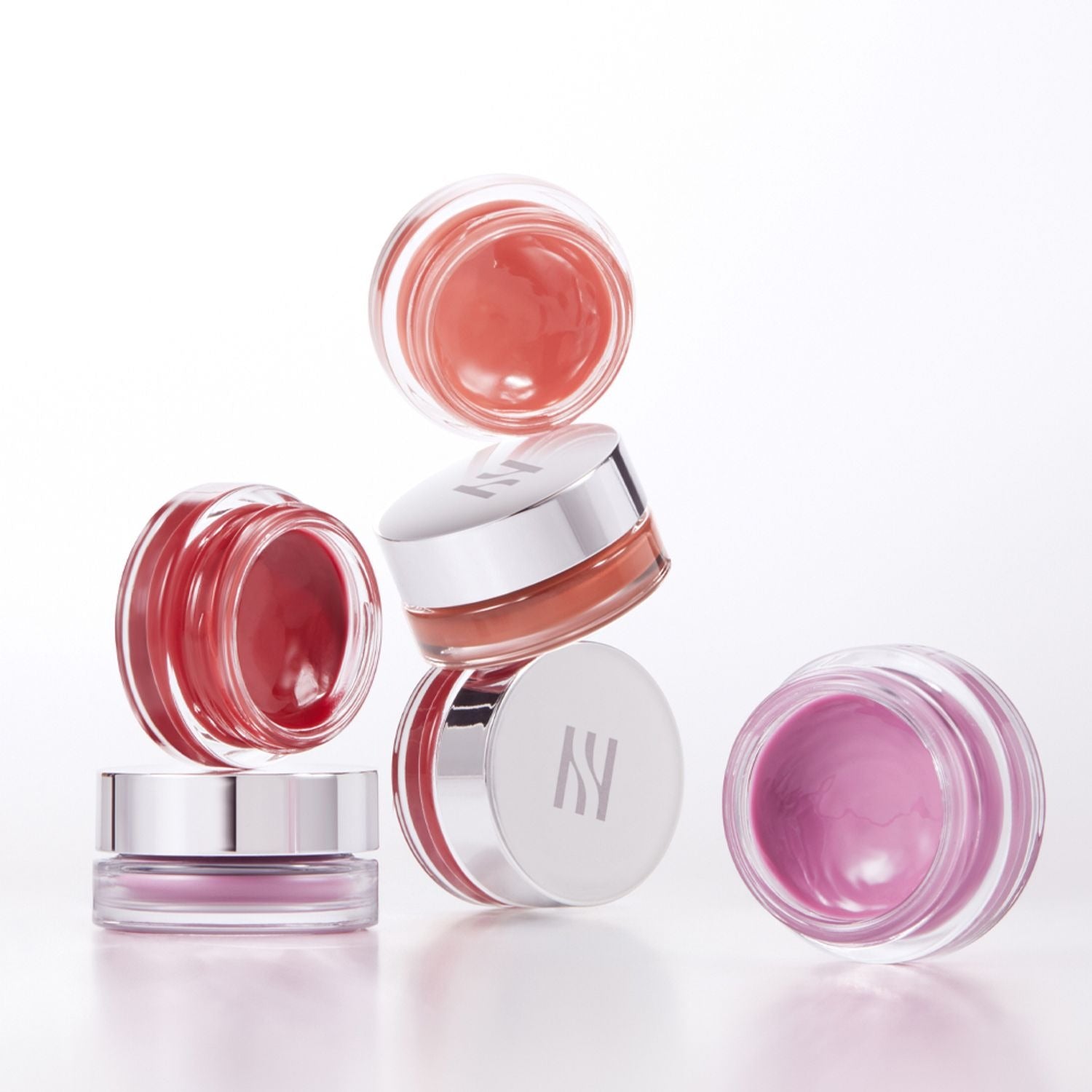 HERA Sensual Lip & Cheek 7g, baume lèvres et joues HERA, packaging rose sur fond blanc, pots et reflet lumineux.