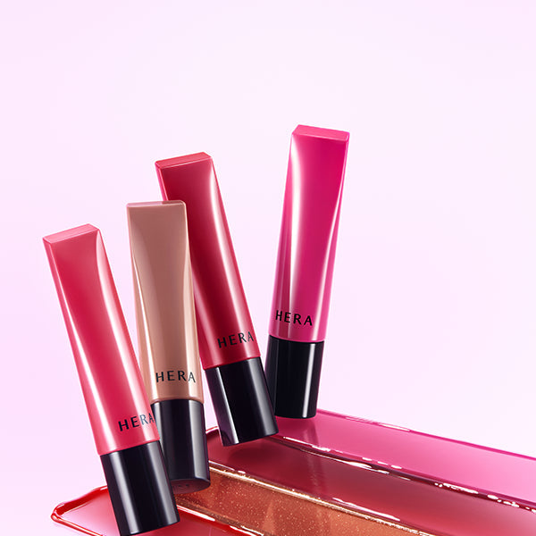 HERA Sensual Tinted Shine Lip Serum 8.5g : tubes brillants sur fond rose, maquillage lèvres HERA.