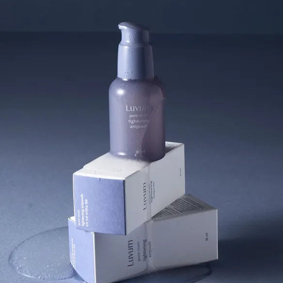 LUVUM Pore Reset Tightening Ampoule 30ml : flacon violet sur cubes blancs, produit de soins visage, fond bleu