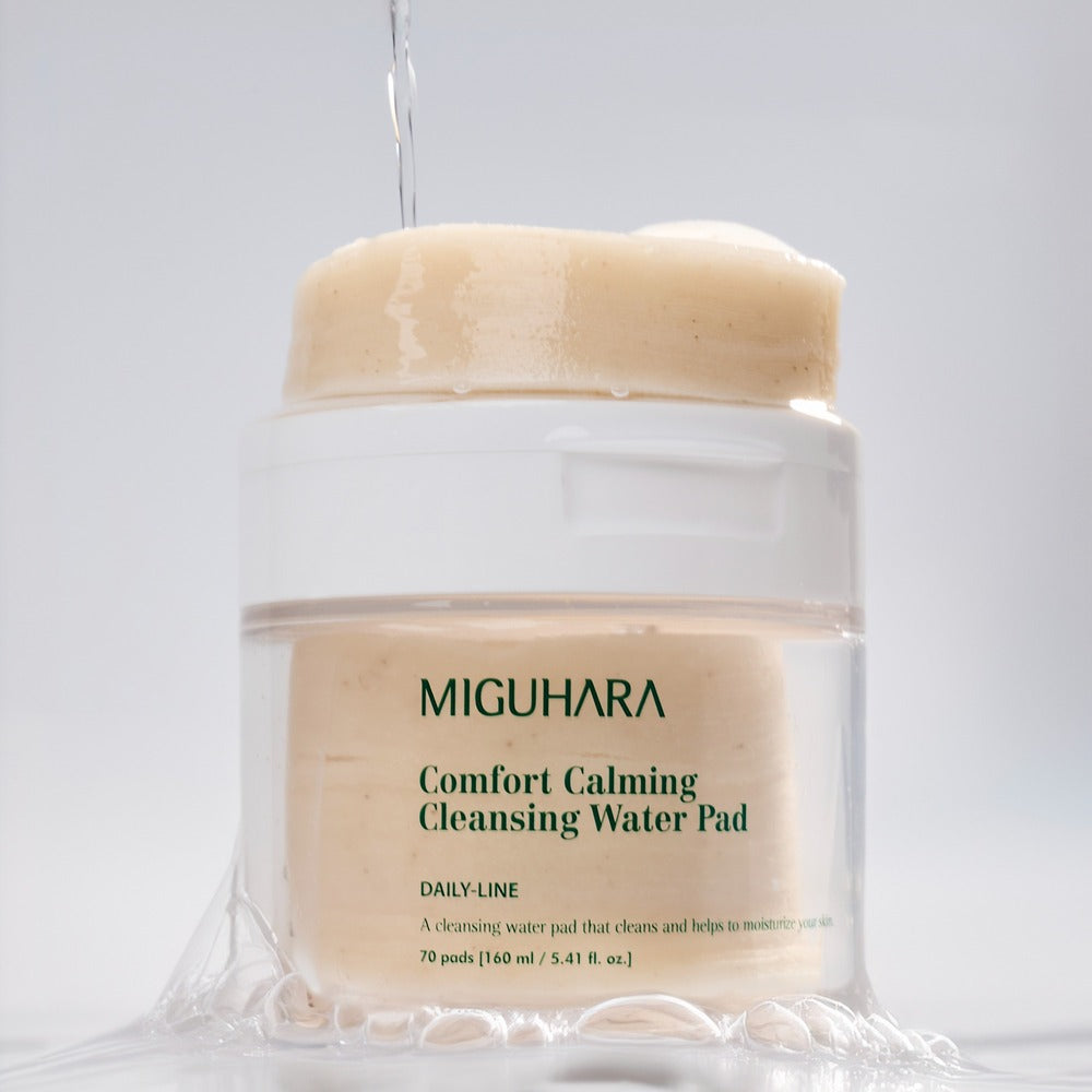 Décris l'image en français : MIGUHARA Comfort Calming Cleansing Water Pads 70 Sheets, bocal crème sur fond blanc.