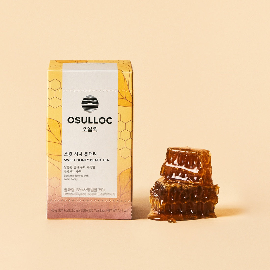 OSULLOC Sweet Honey Black Tea 20 P : boîte et sachets de thé posés sur fond beige, avec gouttes de miel visuelles.