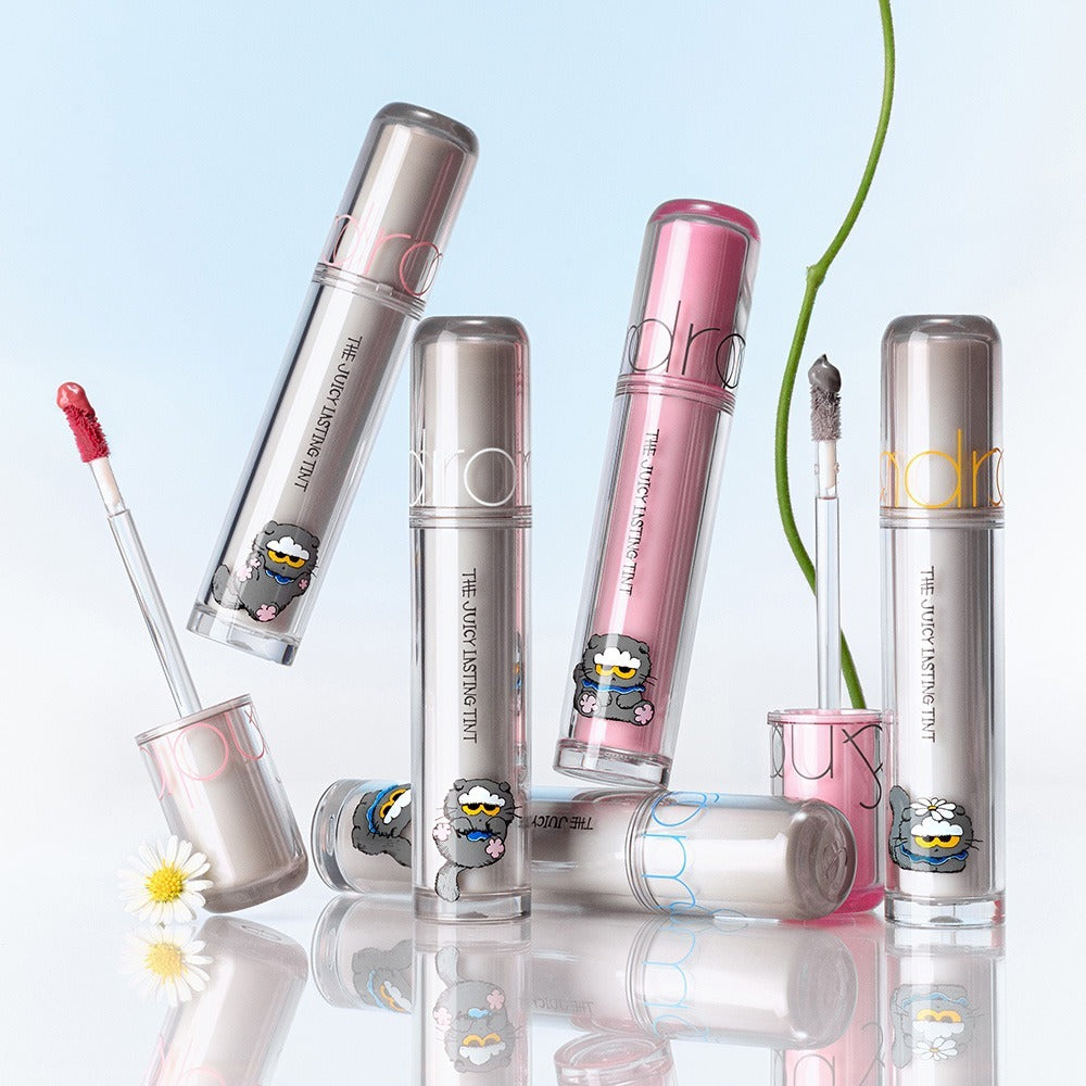 ROMAND x Joanne Friends The Juicy Lasting Tint en plusieurs teintes avec un design ludique sur fond clair.