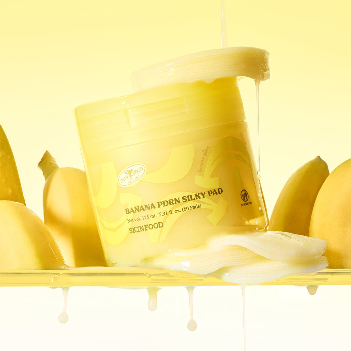 SKINFOOD Banana PDRN Silky Pad 60 sheets de SKINFOOD, en packaging jaune avec bananes, sur fond clair.