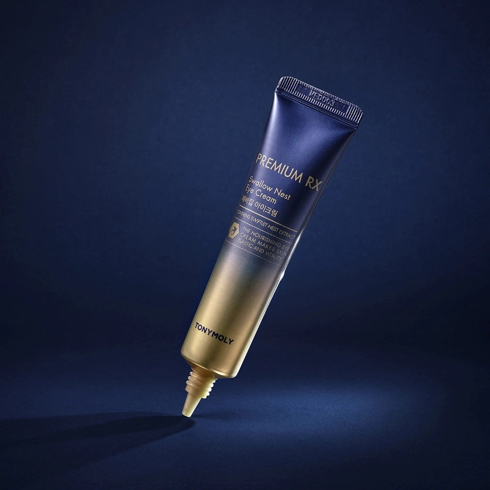 Décris l'image en français : TONY MOLY Premium RX Swallow's Nest Eye Cream sur fond bleu nuit, flacon tube visible.