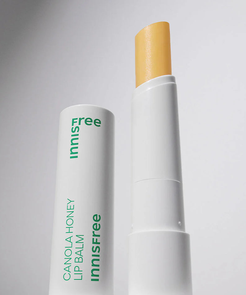 INNISFREE Canola Honey Lip Balm 3.5g : baume à lèvres miel de canola, marque INNISFREE, sur fond clair, packaging blanc/or.