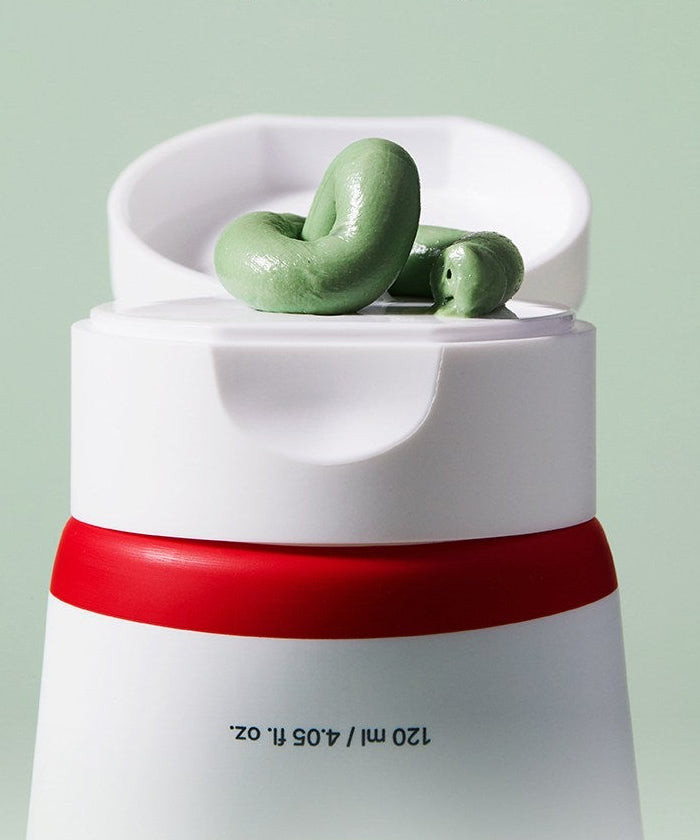 ACWELL Tea Tree Blemish Control Pack Cleanser 120ml sur un fond vert, tube ouvert montrant la texture crémeuse.