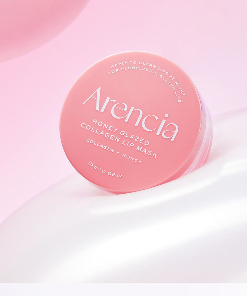 Boîte de 15g du produit ARENCIA Honey Glazed Collagen Lip Mask sur fond rose élégant.