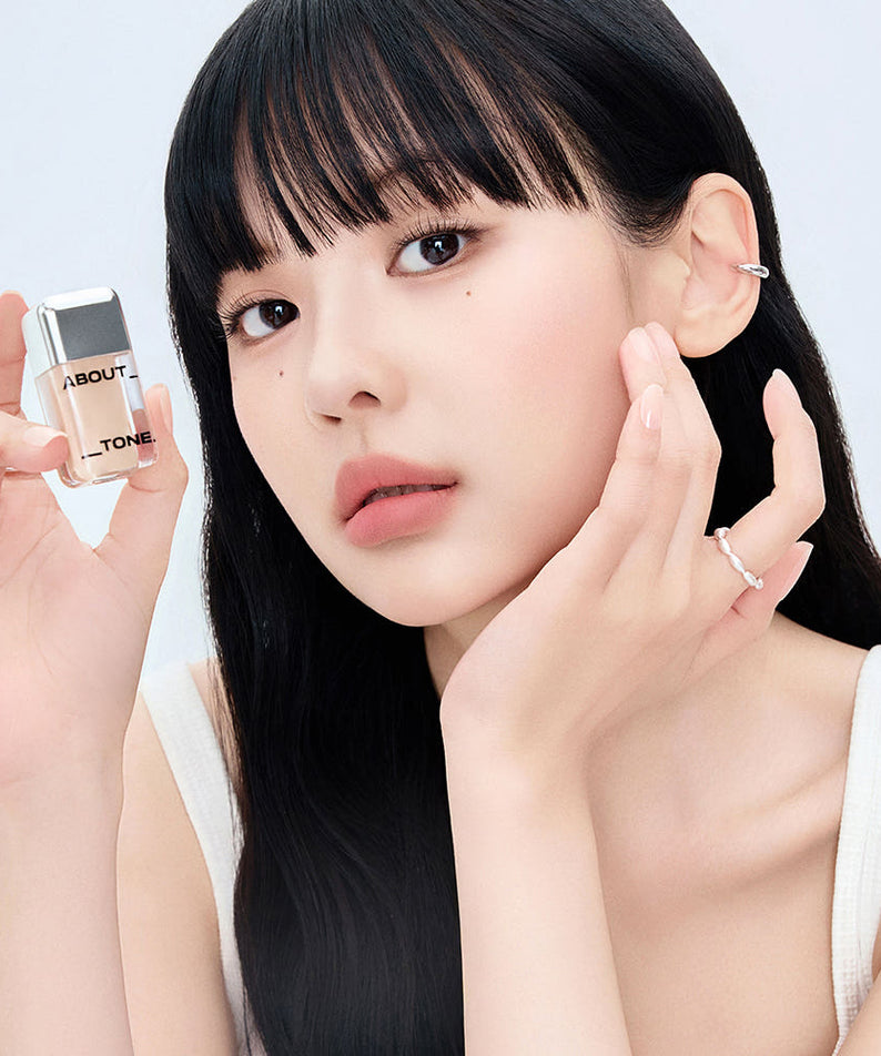 ABOUT TONE  Skin Layer Cover Fit Concealer 5.6g, jeune femme applique le correcteur, produit et marque en gros plan