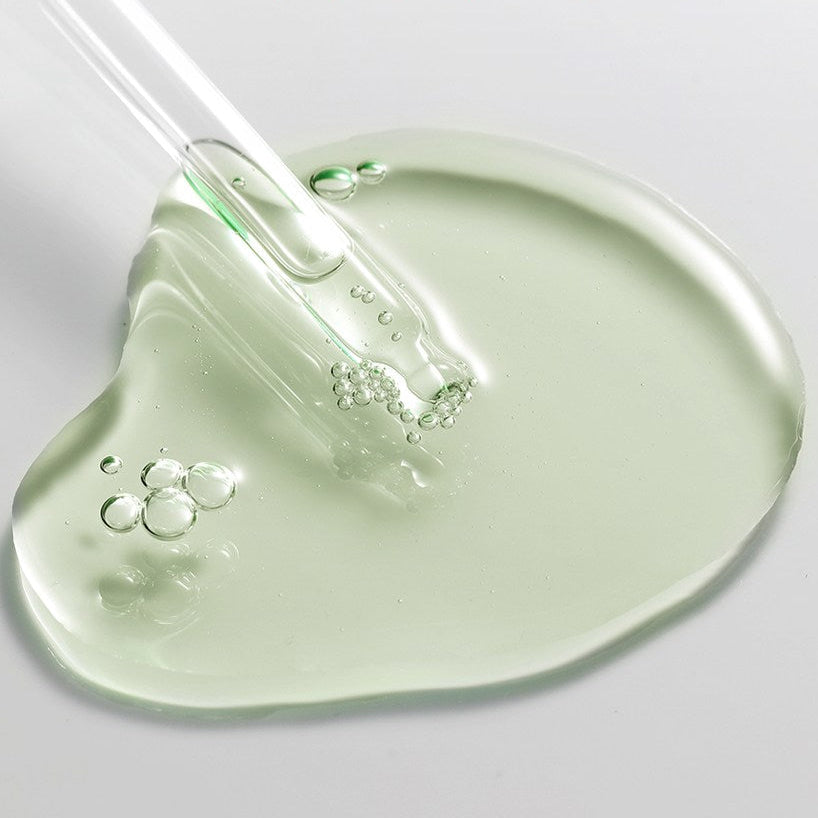ACWELL Tea Tree Blemish Control PDRN Ampoule 80ml : sérum à l’huile d’arbre à thé, gouttes vertes sur fond clair.