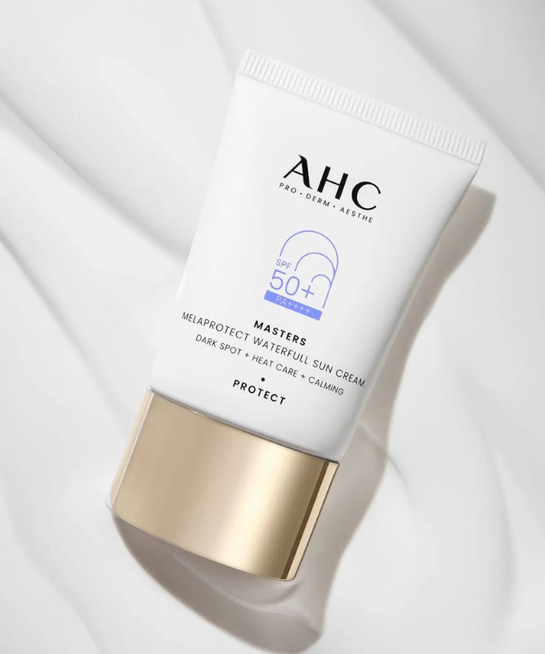 AHC Masters Mela Protect Waterfull Sunscreen 40ml d’AHC, tube SPF50+ sur tissu clair, contexte beauté minimaliste.