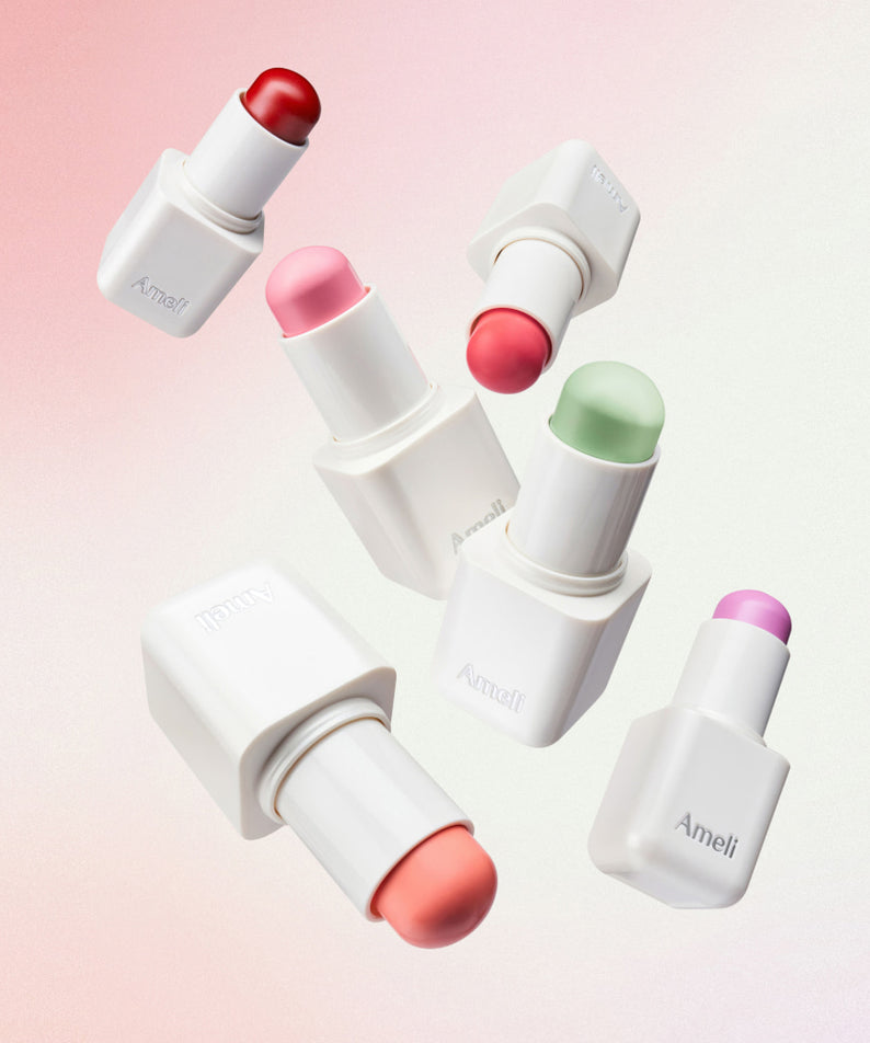 Collection de baumes AMELI Night Series Touch Balm, sticks colorés sur fond rose, beauté et soin des lèvres.