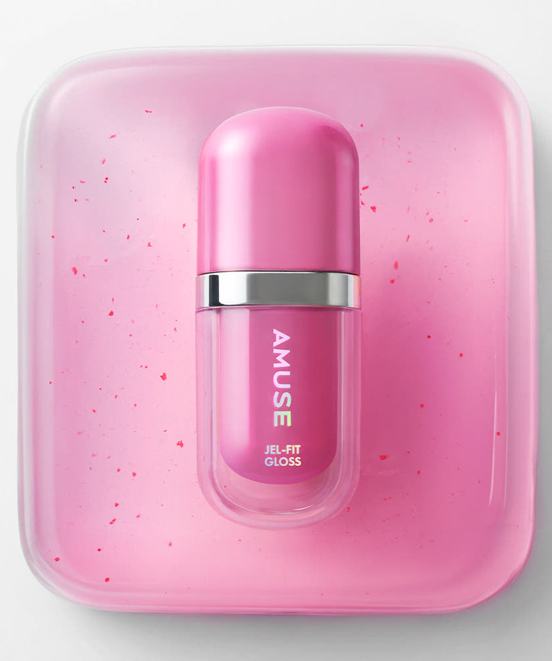 AMUSE Jel Fit Gloss de la marque AMUSE, flacon rose dans un coffret, fond blanc, éclats de paillettes roses.
