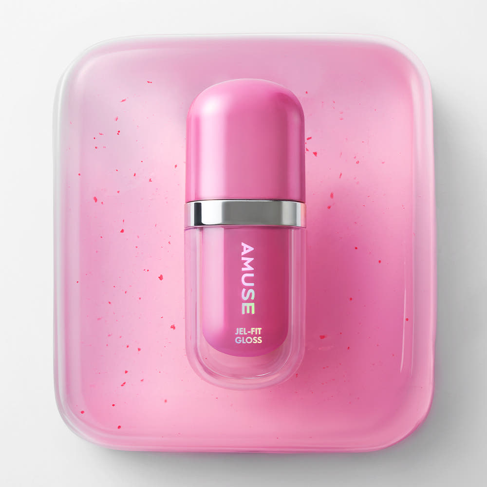 AMUSE Jel Fit Gloss de la marque AMUSE, flacon rose dans un coffret, fond blanc, éclats de paillettes roses.