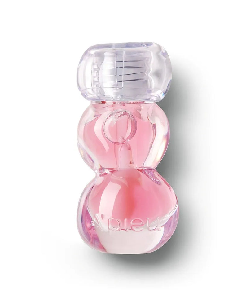 A'PIEU Jelly Honey Lip Oil 4g, baume lèvres miel en gel, flacon rose transparent sur fond blanc.