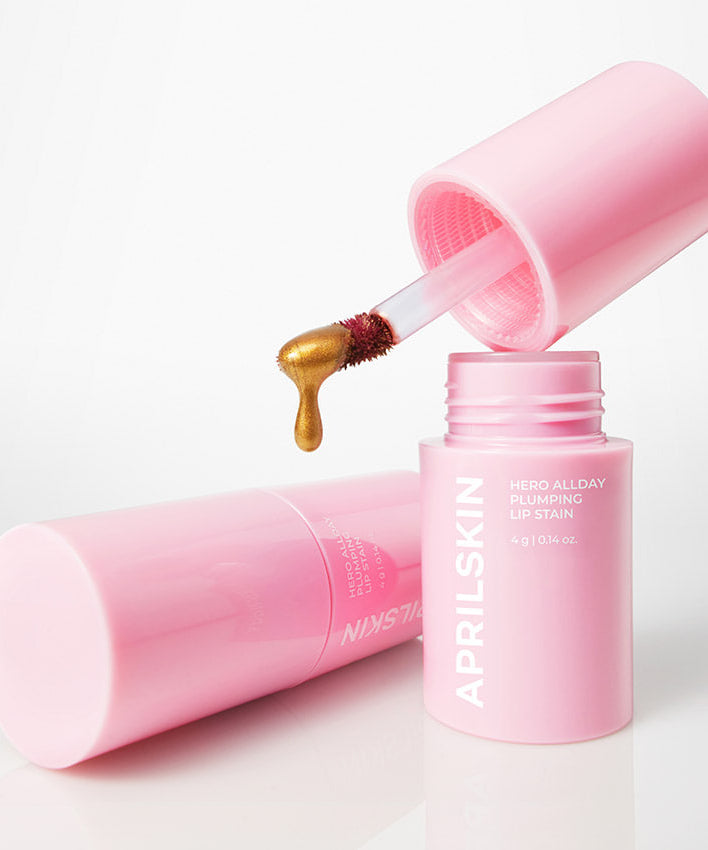 APRILSKIN Hero All Day Plumping Tint : flacon rose et embout applicateur, goutte de texture, visuel produit sur fond clair.