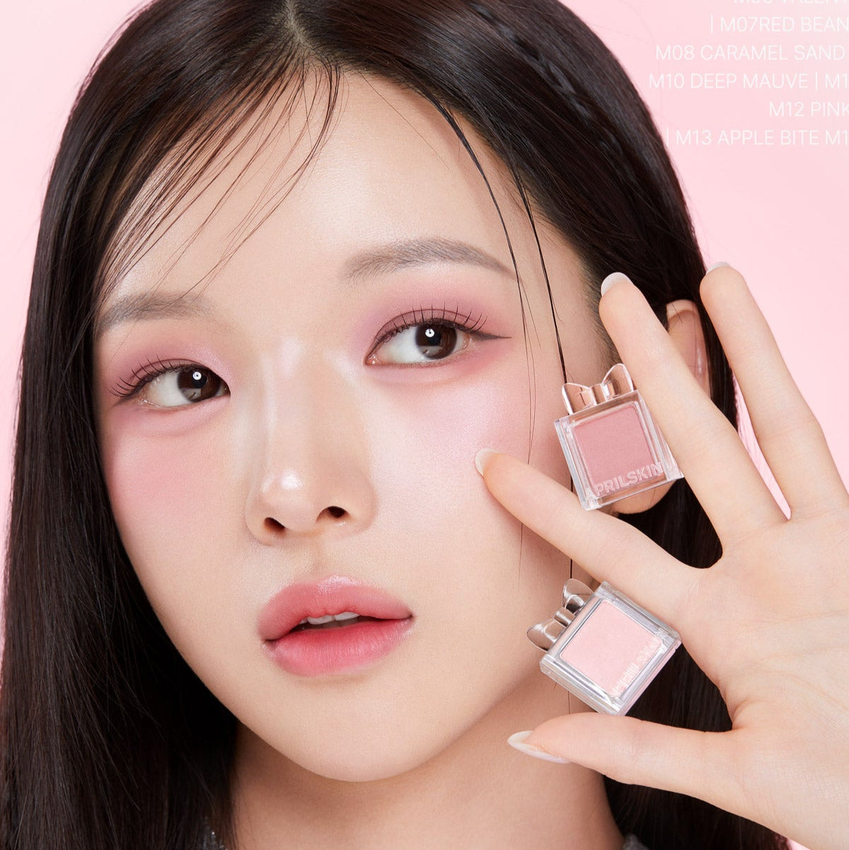 APRILSKIN Slide Pocket Single Shadow, ombre à paupières dans la main, maquillage sur fond rose avec modèle visage de près