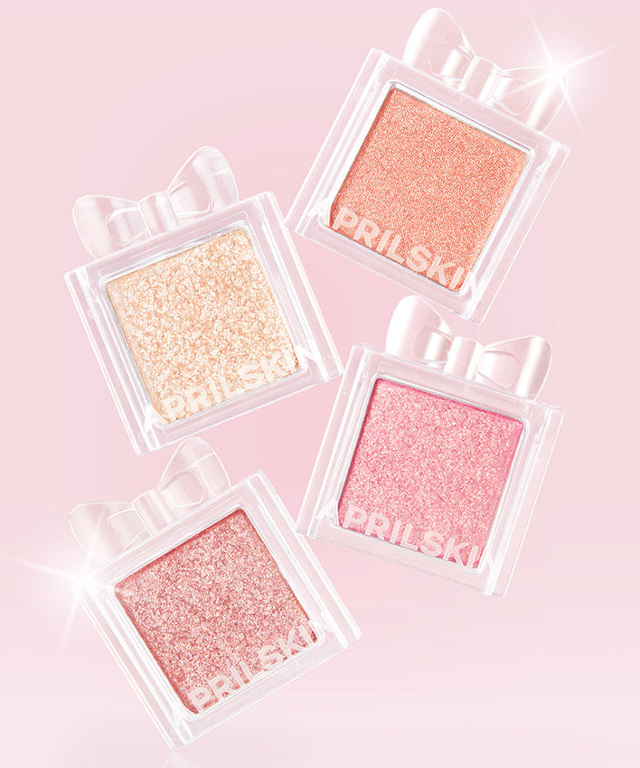 APRILSKIN Slide Pocket Single Shadow en flacons transparents brillants sur fond rose, marque APRILSKIN, maquillage yeux.