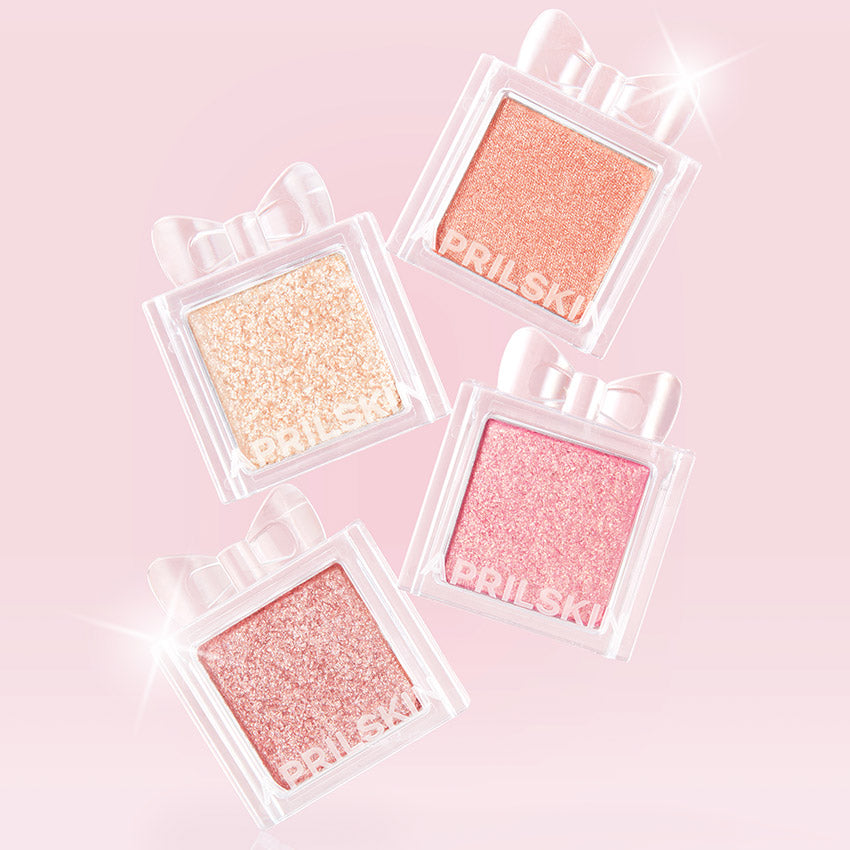 APRILSKIN Slide Pocket Single Shadow en flacons transparents brillants sur fond rose, marque APRILSKIN, maquillage yeux.