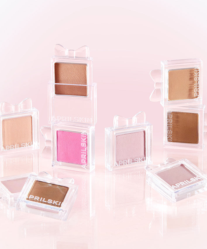 Collection de fards à paupières APRILSKIN Slide Pocket Single Shadow avec nuances variées sur fond rose élégant.