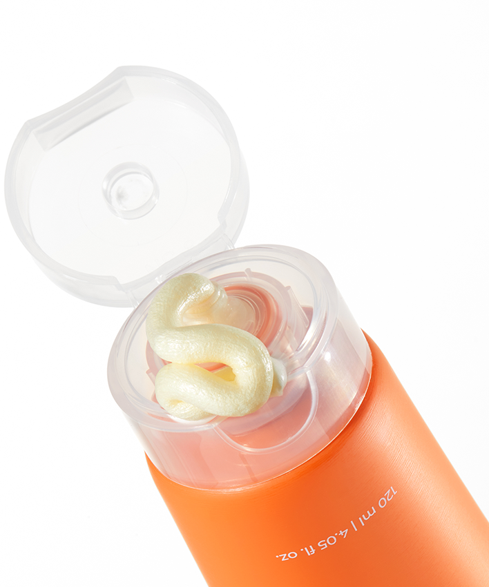 APRILSKIN Real Carrotene Acne Foam Cleanser 120ml d’APRIL SKIN : flacon orange ouvert, mousse visible, fond blanc.