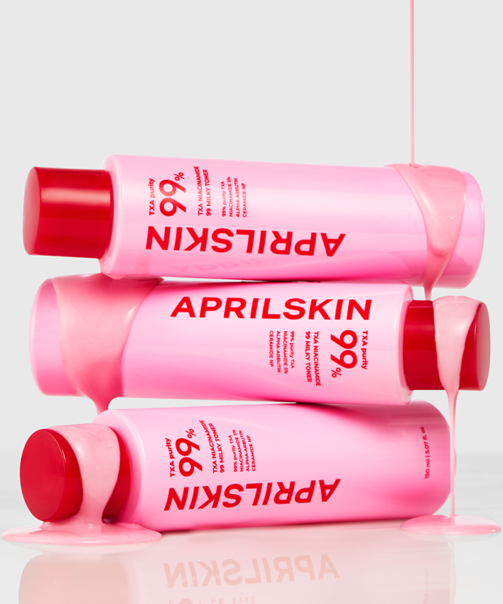 APRILSKIN TXA Niacinamide 99 Milky Toner 150ml empilés avec produit coulant, emballage rose et capuchons rouges, fond blanc.