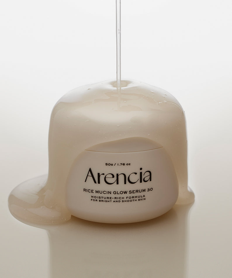ARENCIA Rice Mucin Glow Serum 50g en pot avec sérum qui coule, éclaircissant pour la peau.