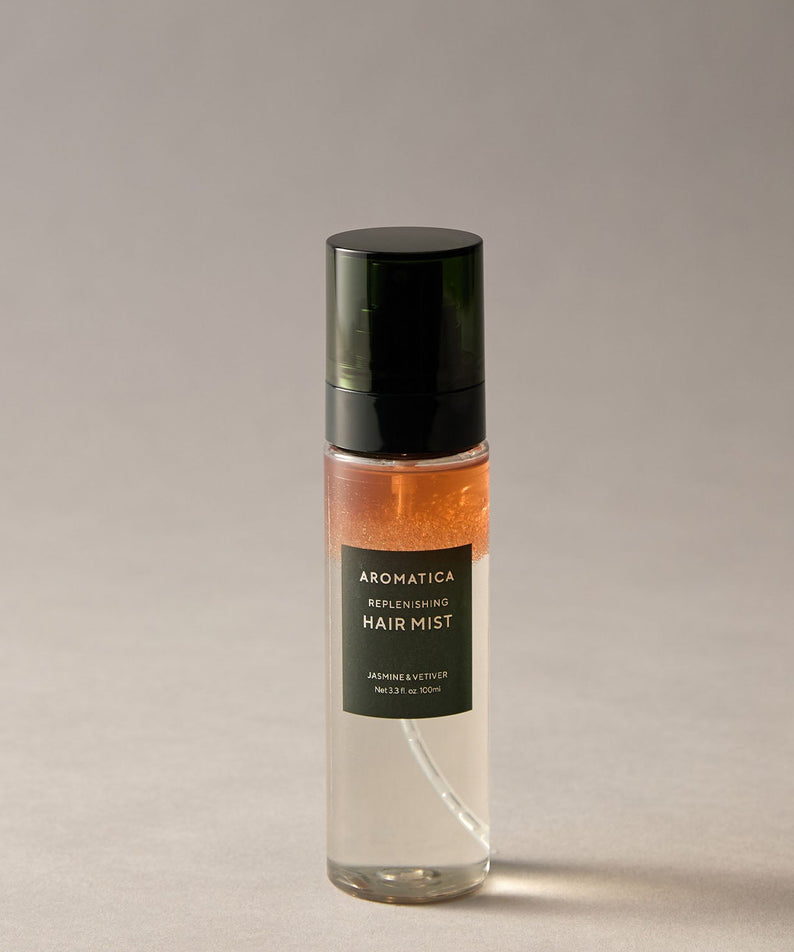 AROMATICA Replenishing Hair Mist Jasmine & Vetiver 100ml sur fond beige, flacon élégant pour soin capillaire naturel.