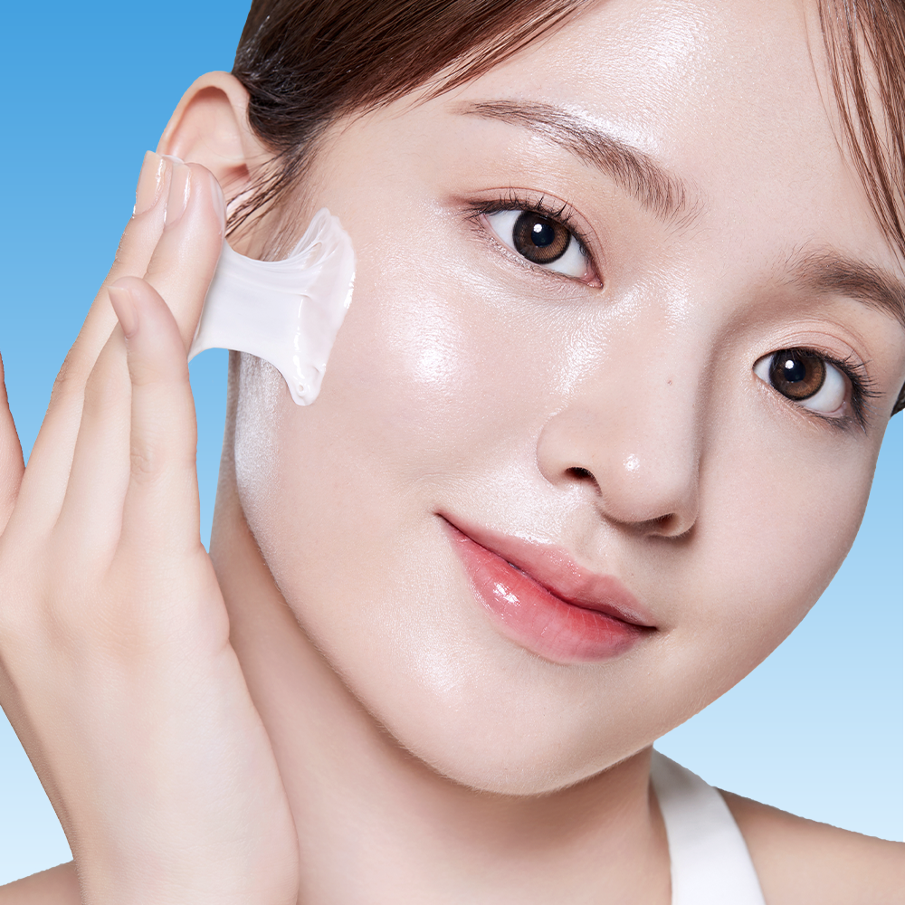 BANOBAGI PDRN 1000 Anti-Aging Cream 50ml, femme applique une crème anti-âge, texture sur peau, fond bleu.