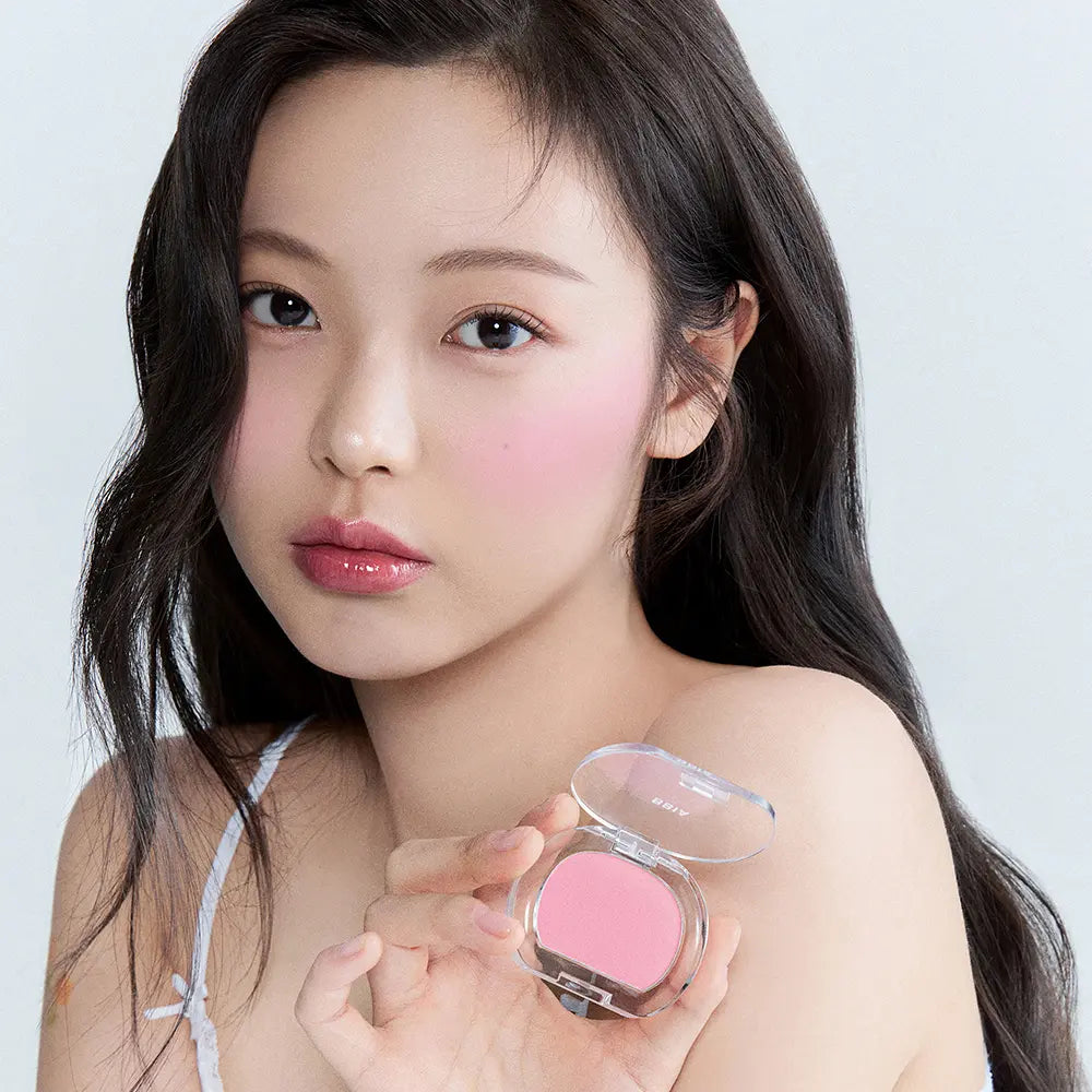BBIA  Pia Last Blush 15 Colors, portrait maquillage sur fond clair, boîte de blush rose en main de la modèle