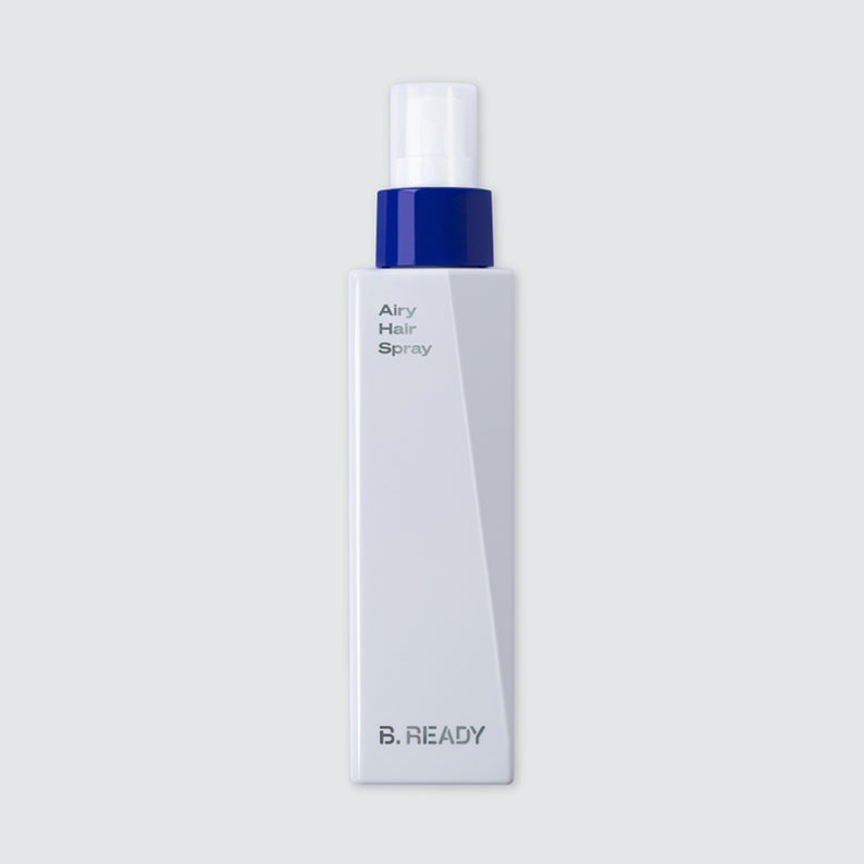 Flacon de BE.READY Airy Hair Spray 200ml en spray élégant pour cheveux volumineux, design moderne, packaging blanc et bleu.