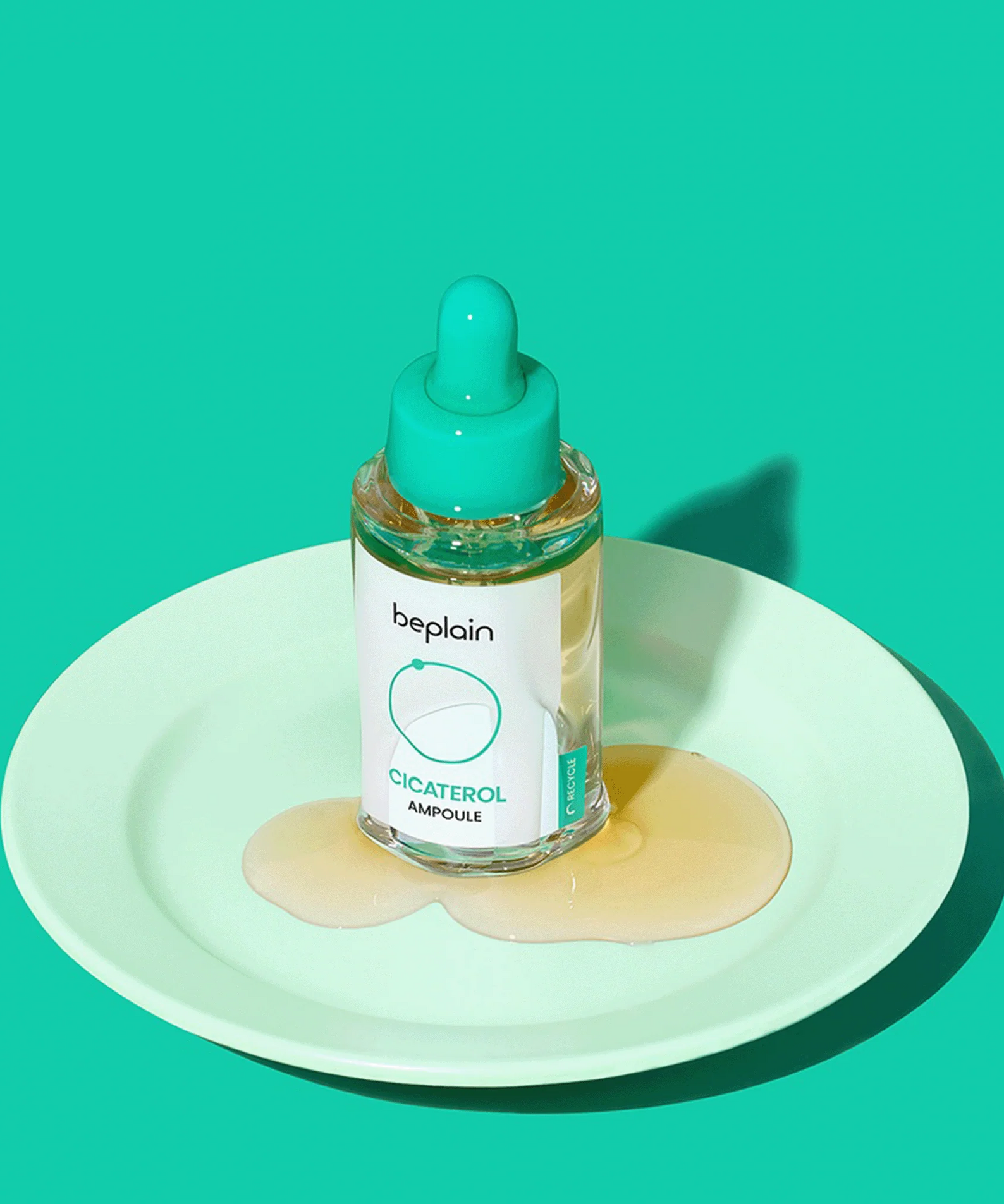 BEPLAIN Cicaterol Ampoule 30ml sur une assiette, flacon à pipette avec liquide, fond turquoise vibrant.