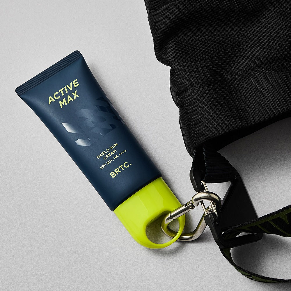 Décris l'image en français en mentionnant BRTC Homme Active Max Sheild Sunscreen 50ml de BRTC, tube sur fond gris.