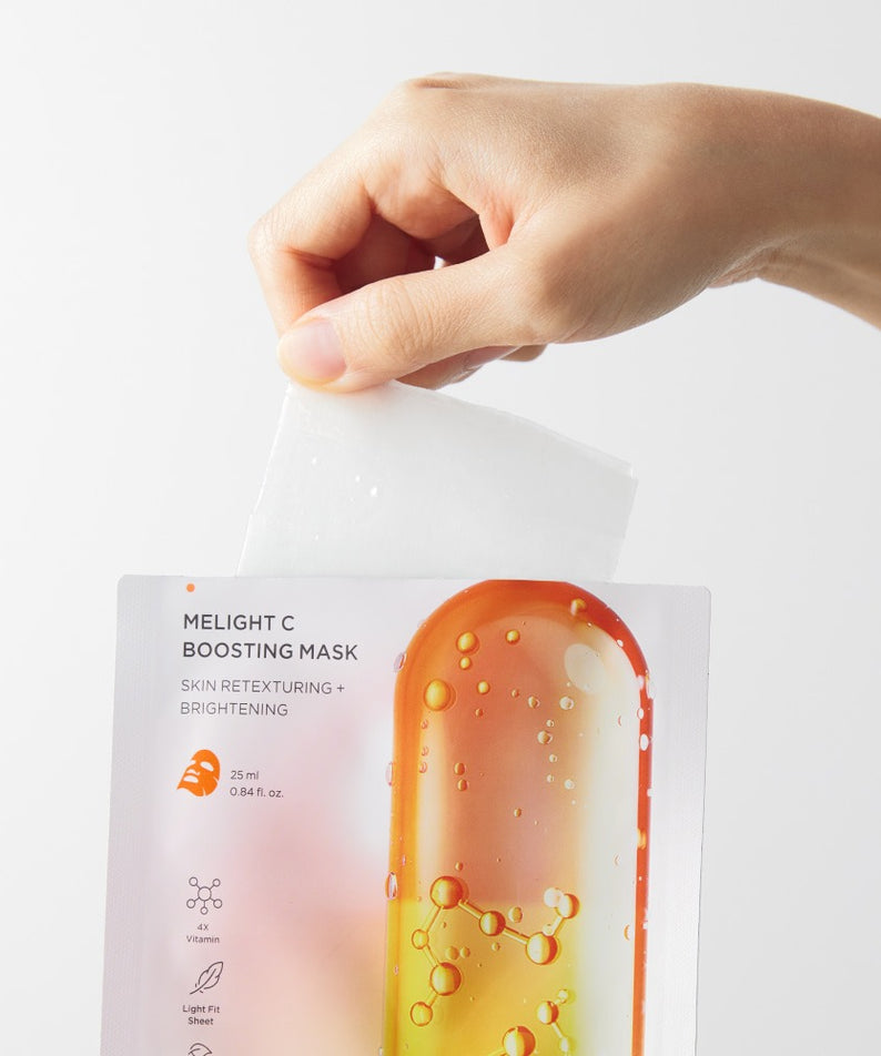 Décris l'image en français : BRTC Melight C Boosting Mask 10 Sheets, la main tient un masque en film, fond blanc.
