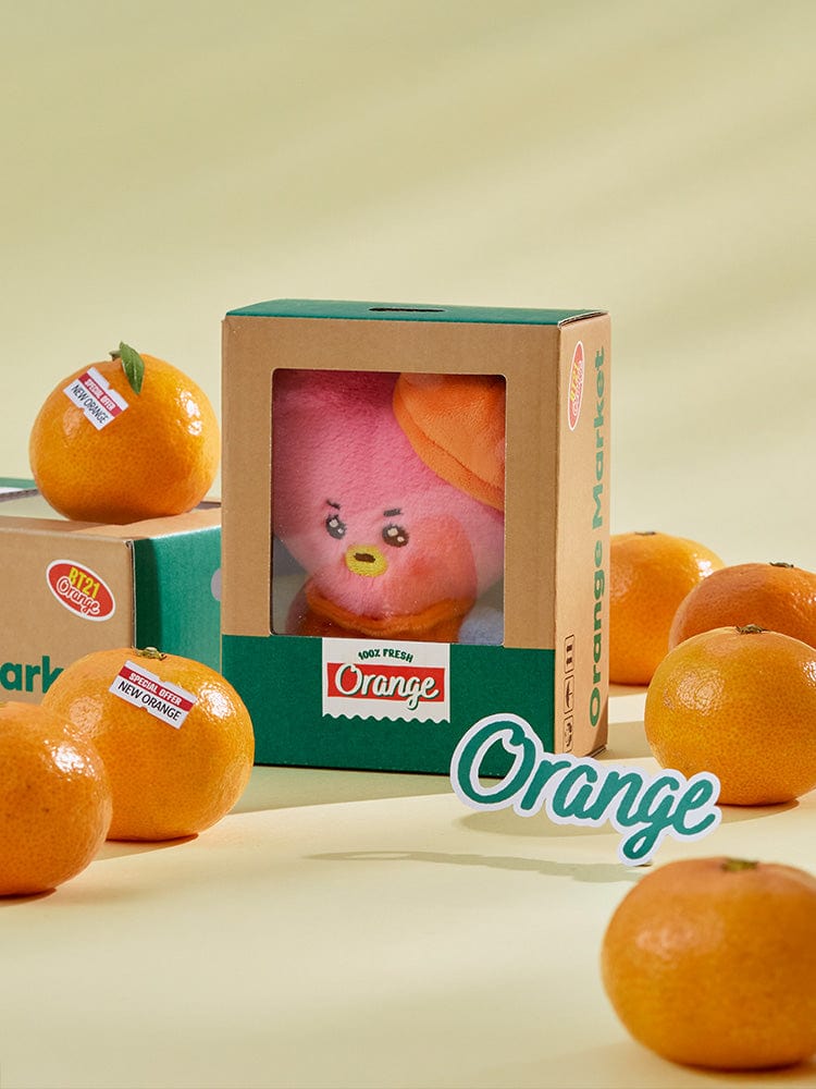 BT21 TATA BABY PLUSH ORANGE PARTY, peluche Orange TATA de V de BTS, en boîte, sur fond clair, décor orange.