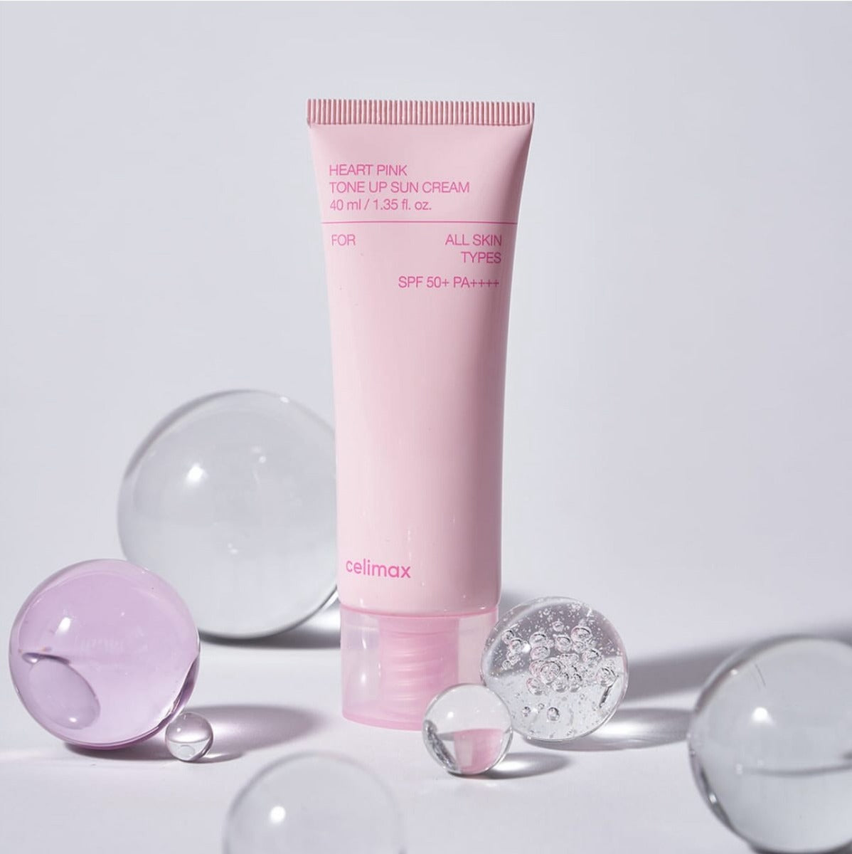 CELIMAX Heart Pink Tone-up Sun Cream 40ml de la marque Celimax, tube rose sur fond clair avec bulles décoratives.