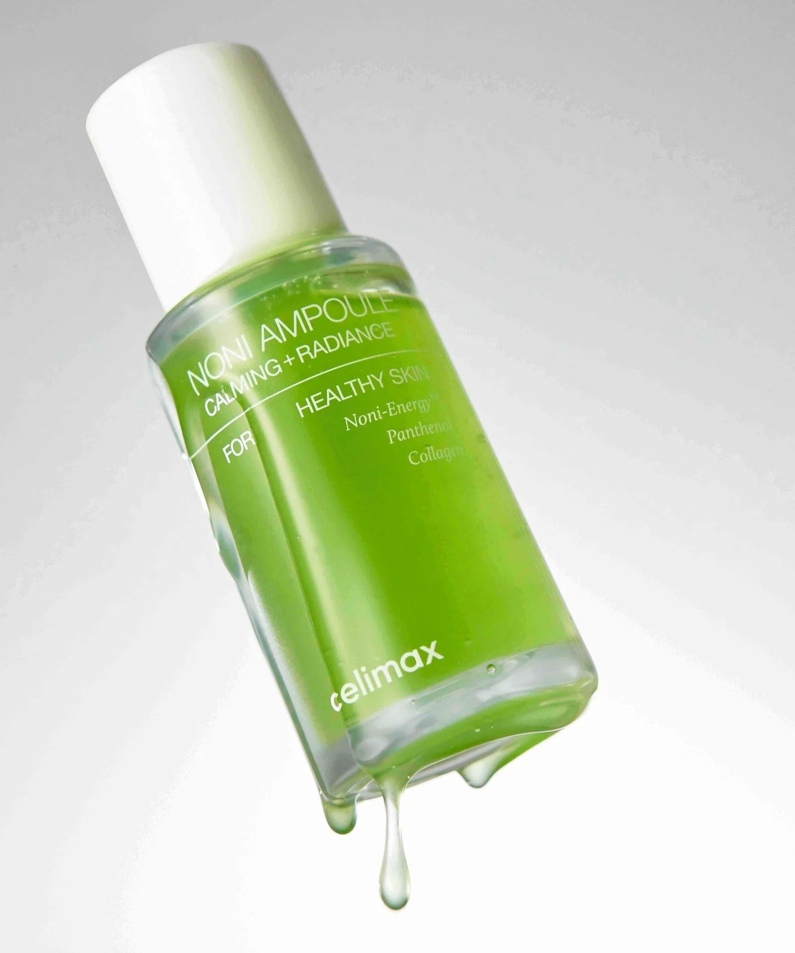 Image du produit CELIMAX Noni Ampoule Calming+Radiance 100ml avec liquide vert vibrant pour soins de la peau apaisants et éclatants.