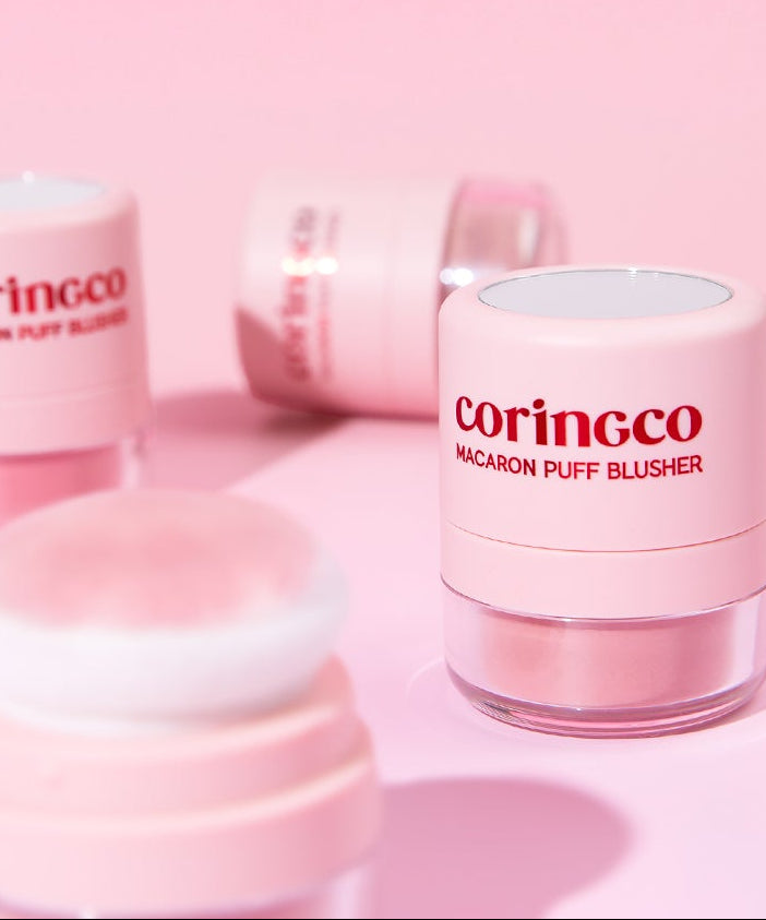 CORINGCO Macaron Puff Blusher de la marque CORINGCO, packaging rose sur fond pastel, produit maquillage en gros plan.