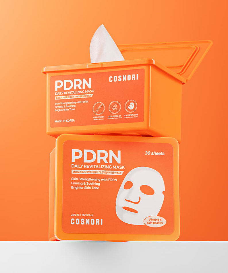 COSNORI PDRN Daily Revitalizing Mask 30 sheets en packaging orange, marque COSNORI, visage avec masque en arrière-plan.