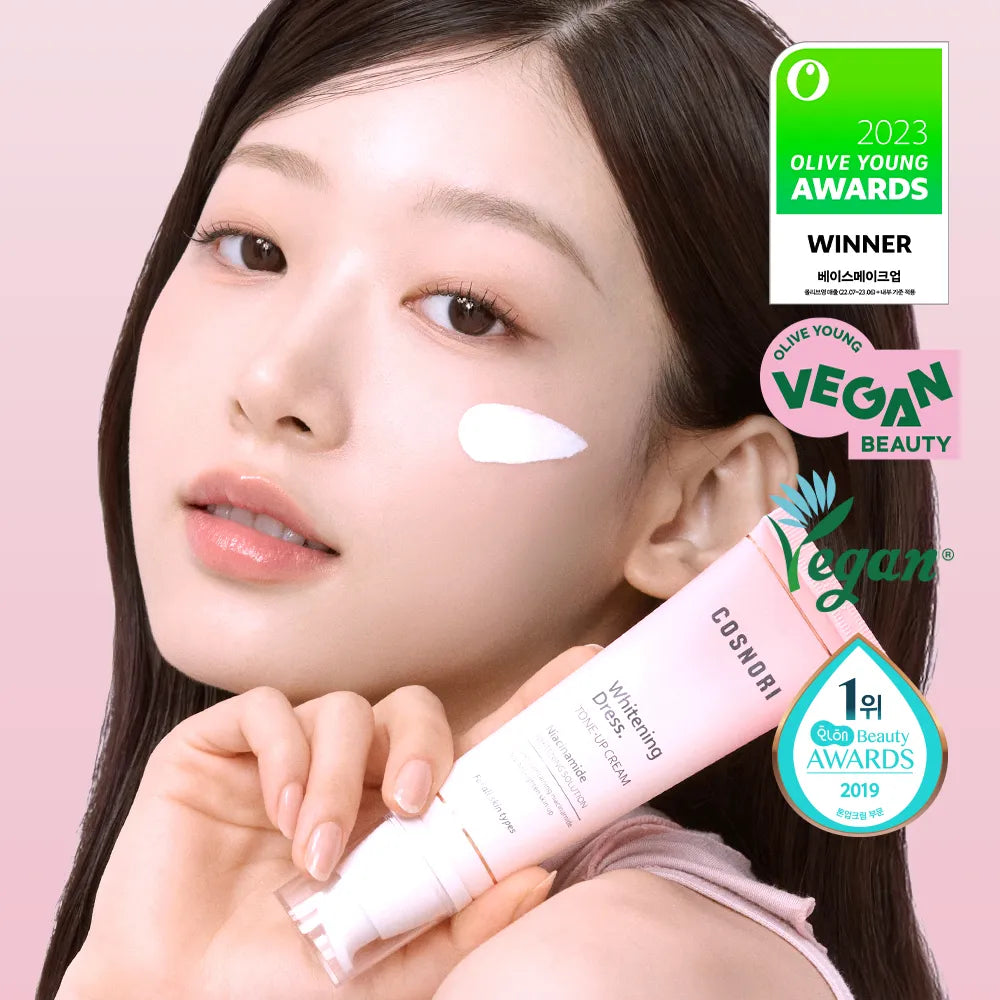 COSNORI Whitening Dress Tone-Up Cream 50ml de la marque COSNORI, sur visage maquillé avec main, fond rose.